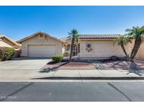 Charming single-story home featuring a two-car garage, desert landscaping, and a welcoming front entrance at 17741 N Desert Flower Trl, Surprise, AZ 85374