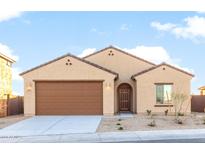 Charming single-story home featuring a two-car garage, neutral paint, and simple desert landscaping at 2434 S 246Th Ln, Buckeye, AZ 85326