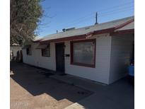 Charming single-story home with white siding, red trim, and a well-maintained front yard at 2937 W Bethany Home Rd, Phoenix, AZ 85017