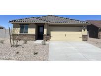 Single story home with a two car garage and well maintained landscape at 627 W Pintail Dr, Casa Grande, AZ 85122