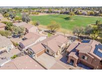 Expansive home near lush green golf course showcasing desert landscaping and neutral color scheme at 7227 S Golfside Ln, Phoenix, AZ 85042