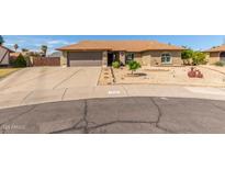 Well-maintained home with desert landscaping, a two-car garage, and a brick facade at 7542 W Dahlia Dr, Peoria, AZ 85381