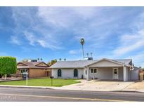 Charming single-story home with a covered parking area and well-maintained front yard at 9716 N 55Th Ave, Glendale, AZ 85302