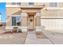 Inviting front entrance with a decorated door, leading to a charming home with well-manicured landscaping at 1309 E Daisy Way, San Tan Valley, AZ 85143