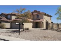 Beige two-story home featuring a symmetrical design, archway and a low-maintenance rock yard at 181 S 227Th Ln, Buckeye, AZ 85326