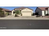 Charming single-story home featuring desert landscaping and a two-car garage at 18563 N 116Th Dr, Surprise, AZ 85378