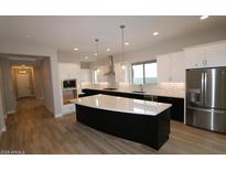 Spacious kitchen with large island, stainless steel appliances, and modern finishes at 1956 W Rowel Rd, Phoenix, AZ 85085