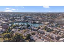 Beautiful aerial view of a lakeside community showcasing well-maintained homes, lush landscaping and blue skies at 19934 N 77Th Ave, Glendale, AZ 85308