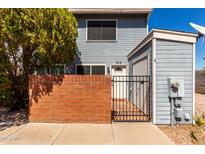 Charming two-story home featuring a brick wall, gated front porch, and light blue wood paneling at 2301 E University Dr # 505, Mesa, AZ 85213