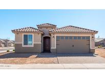 Charming single-story home with a tile roof, neutral stucco, and a two-car garage at 26905 W Melinda Ln, Buckeye, AZ 85396