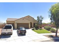 Charming single-story home featuring a tile roof, well-maintained front yard, and a spacious two-car garage at 27527 N 171St Dr, Surprise, AZ 85387