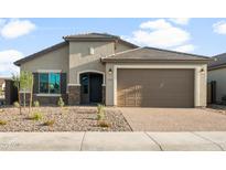 Charming single-story home featuring a two-car garage, stone accents, and low maintenance desert landscaping at 6247 W Georgetown Way, Florence, AZ 85132