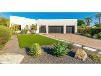 Stunning modern home with a landscaped yard and two-car garage at 9845 N 79Th Way, Scottsdale, AZ 85258