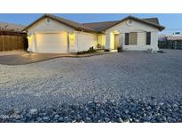Charming single-story home featuring a two-car garage and low-maintenance desert landscaping at 10241 E La Palma Ave, Gold Canyon, AZ 85118