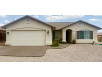 Charming single-story home featuring a stucco facade, tile roof, and a low-maintenance rock yard at 10241 E La Palma Ave, Gold Canyon, AZ 85118