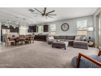 Open-concept living area connecting the kitchen, dining, and living spaces at 10454 W Maya Way, Peoria, AZ 85383