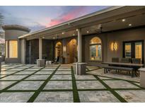 An elegant covered patio with a seating area and an outdoor kitchen, perfect for entertaining guests at 11320 N Crestview Dr, Fountain Hills, AZ 85268