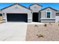 Charming single-story home features a two-car garage, desert landscaping, and an inviting front entryway at 11894 E Aster Ln, Florence, AZ 85132