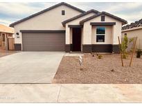 Charming single-story home featuring a two-car garage and low maintenance desert landscaping at 11943 E Aster Ln, Florence, AZ 85132