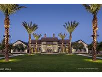 Stately clubhouse entrance with manicured lawn and palm trees, exuding luxury and community at 1948 W Rowel Rd, Phoenix, AZ 85085