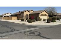 Charming single-story home with a well-manicured yard and neutral paint palette and an American flag at 2132 W Gold Dust Ave, San Tan Valley, AZ 85144