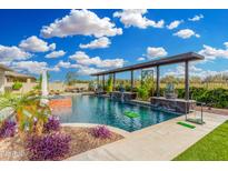 Resort-style pool and spa featuring a pergola, lush landscaping and putting green creates a backyard oasis at 22867 E Via Las Brisas --, Queen Creek, AZ 85142