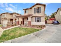 Charming two-story home featuring a landscaped front yard and a welcoming covered porch with seating at 2307 E Pecan Rd, Phoenix, AZ 85040