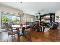 Open concept living room and dining area with hardwood floors and comfortable seating at 33550 N Dove Lakes Dr # 1041, Cave Creek, AZ 85331