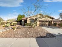 Charming home featuring a well-maintained desert landscape and a paved driveway at 41220 N Belfair Way, Anthem, AZ 85086