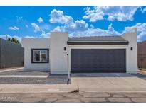 Charming single-story home featuring a modern stucco exterior and a two-car garage at 5109 W Sanna St, Glendale, AZ 85302
