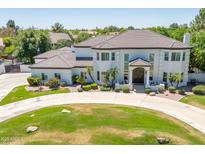 Stunning two-story home with a circular driveway and beautifully manicured landscaping at 521 E Horseshoe Ave, Gilbert, AZ 85296