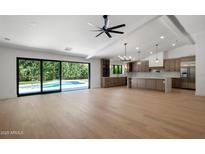Bright, open-concept living space with kitchen, and access to the pool through sliding doors at 7528 E Windrose Dr, Scottsdale, AZ 85260
