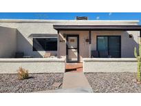 Charming single-story home with desert landscaping and a cozy covered front porch at 907 E Lancaster Cir, Florence, AZ 85132