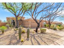 Charming home featuring desert landscaping, a tile roof, and mature trees providing ample shade at 9327 E Whitewing Dr, Scottsdale, AZ 85262