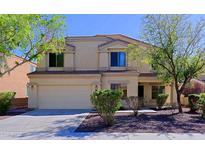 Two-story home with a neutral color palette, well-maintained landscaping, and attached two-car garage at 9541 W Frank Ave, Peoria, AZ 85382