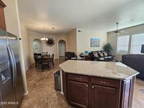 Open concept kitchen with stainless steel appliances and granite countertops at 14575 W Mountian View Blvd # 10115, Surprise, AZ 85374