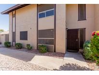 Charming two-story home featuring a front door with security screen and well-maintained landscaping at 17808 N 45Th Ave, Glendale, AZ 85308