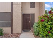 Inviting front entrance features a secure metal door and lush, colorful landscaping around the walkway at 17808 N 45Th Ave, Glendale, AZ 85308