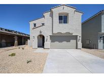 Charming two-story home with a two-car garage and a low-maintenance gravel front yard at 18244 W Daley Ln, Surprise, AZ 85387
