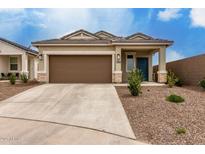 Inviting single-story home featuring a two-car garage and low-maintenance desert landscaping at 10347 S Saguaro Dr, Apache Junction, AZ 85120