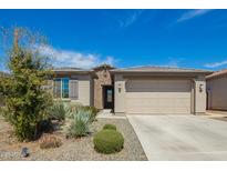 Charming single-story home featuring desert landscaping, a stone facade, and a two-car garage at 11574 W Levi Dr, Avondale, AZ 85323