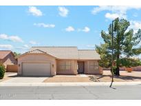 Charming single-story home featuring a tile roof, desert landscaping, and a two-car garage on a sunny day at 1245 E Waterview Pl, Chandler, AZ 85249