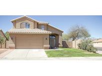 Charming two-story home featuring a tile roof, well-maintained lawn, and inviting curb appeal at 13416 S 47Th St, Phoenix, AZ 85044