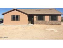 Charming single-story home featuring neutral siding, shuttered windows, and a desert landscape at 22113 W Laura St, Wittmann, AZ 85361
