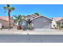 Charming single-story home with desert landscaping, neutral stucco, and a two-car garage in a sunny setting at 2456 E Hancock Trl, Casa Grande, AZ 85194