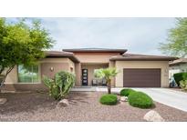 Inviting single-story home featuring a desert landscaped yard and a two-car garage at 29854 N 132Nd Dr, Peoria, AZ 85383