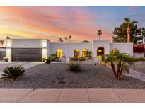 Beautiful single-story home with desert landscaping and a view of the sunset sky at 5642 E Justine Rd, Scottsdale, AZ 85254