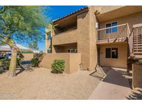 Inviting condo exterior featuring a private balcony, neutral stucco, and low-maintenance desert landscaping at 5877 N Granite Reef Rd # 1155, Scottsdale, AZ 85250