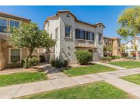 Charming two-story townhome with stucco exterior, a well-manicured lawn, and mature trees in a friendly neighborhood at 927 W Wendy Way, Gilbert, AZ 85233