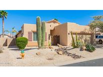 Charming desert home featuring a low-maintenance yard with native cacti and desert landscaping at 10322 E Excavation Ct, Gold Canyon, AZ 85118